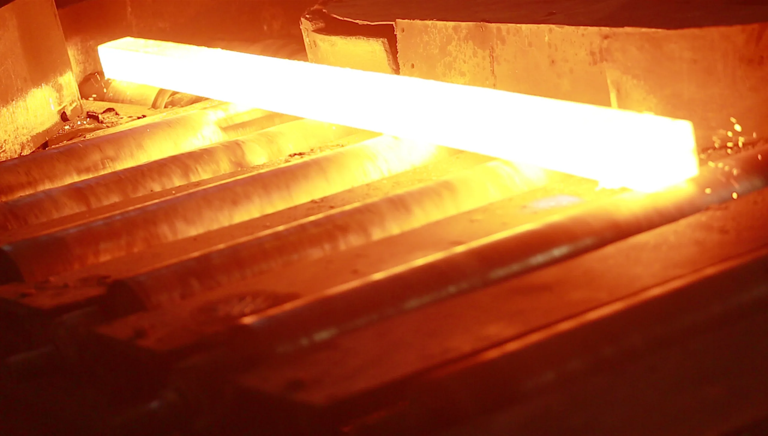 A white-hot billet leaving the reheating furnace